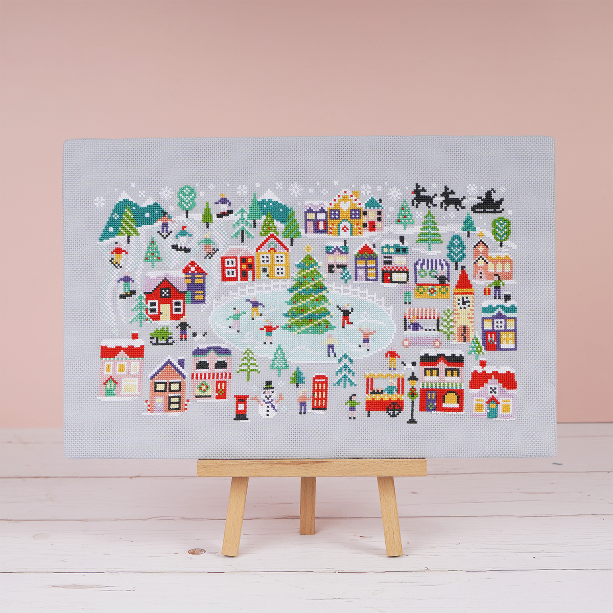 Christmas Wonderland cross stitch design, a snowy festive village stitched on grey 14 count aida