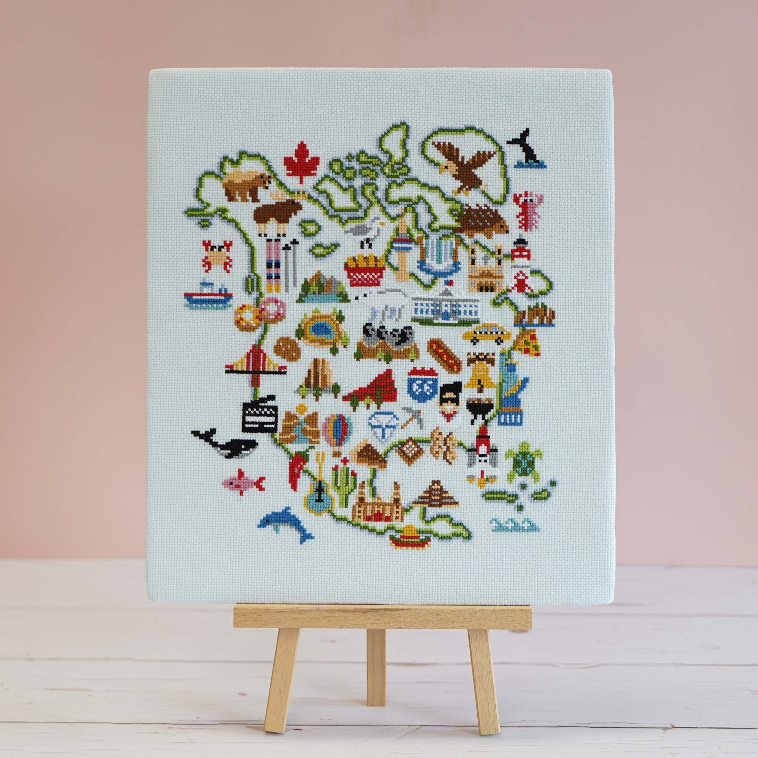 North American Adventure map cross stitch design on pale blue 14 count aida, stitched in 14 DMC shades