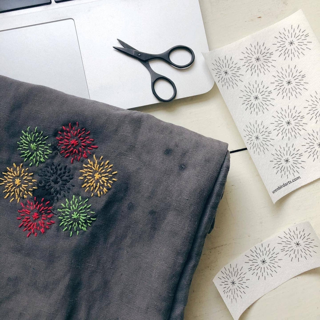Stick the transfer over the hole, stitch the pattern, rinse the paper away