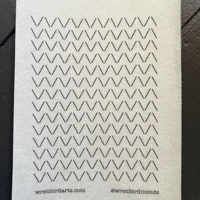 Stick the transfer over the hole, stitch the pattern, rinse the paper away
