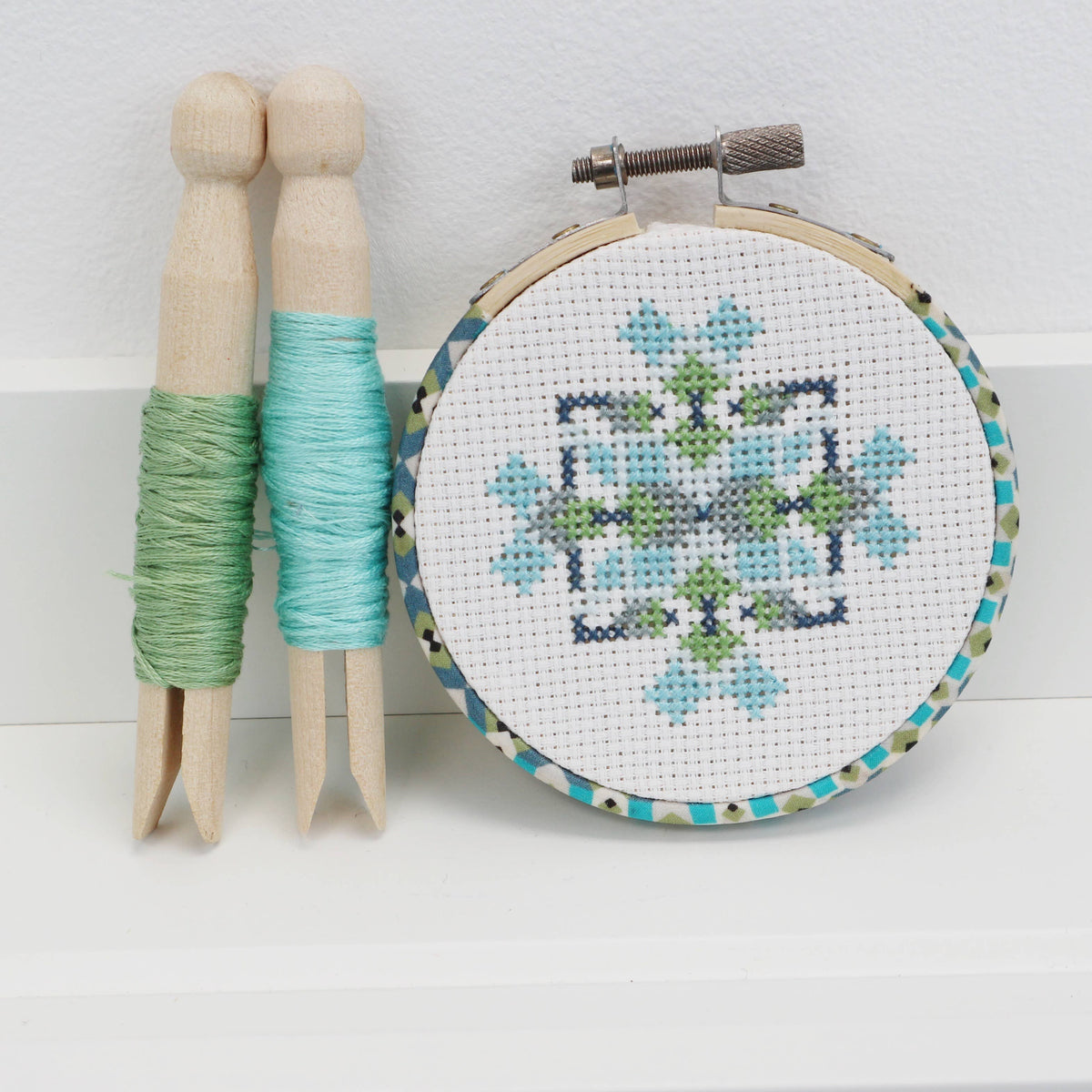 Mini geometric counted cross stitch kit by Stitchkits Crafts in a 3 inch Liberty wrapped hoop, blue and green