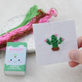 Kawaii flowering cactus cross stitch design on blue 14 count Aida