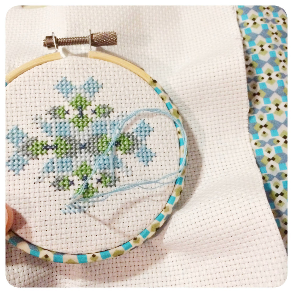 Mini geometric cross stitch hoop, small enough to hang on a tree
