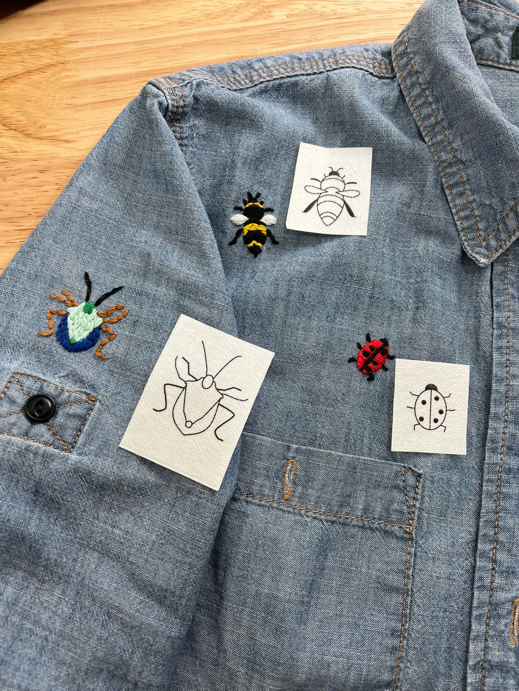 Fifteen insect designs including ants, ladybugs, bees, a butterfly and a spider web