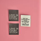 Love in Every Stitch sew-in label in grey on embroidered satin