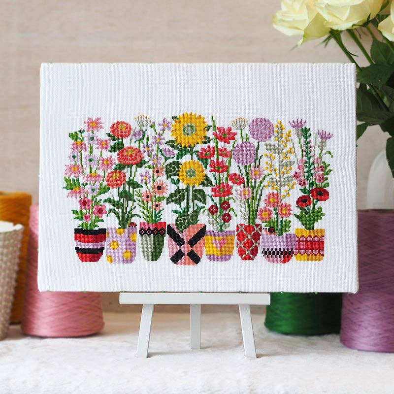 Bloom and Grow modern floral cross stitch design in a long horizontal band on white 14 count aida