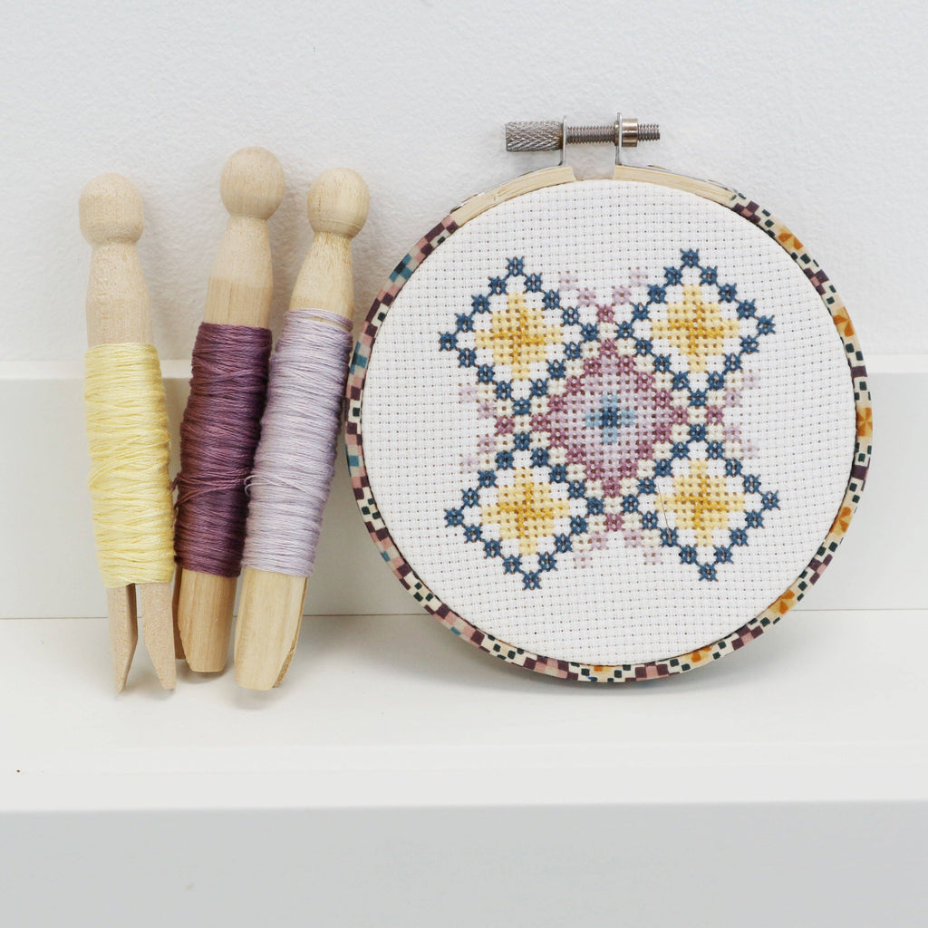 Geometric counted cross stitch kit by Stitchkits Crafts in a 4 inch Liberty wrapped hoop, purple and yellow