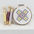 Geometric counted cross stitch kit by Stitchkits Crafts in a 4 inch Liberty wrapped hoop, purple and yellow