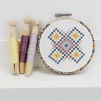 Geometric counted cross stitch kit by Stitchkits Crafts in a 4 inch Liberty wrapped hoop, purple and yellow