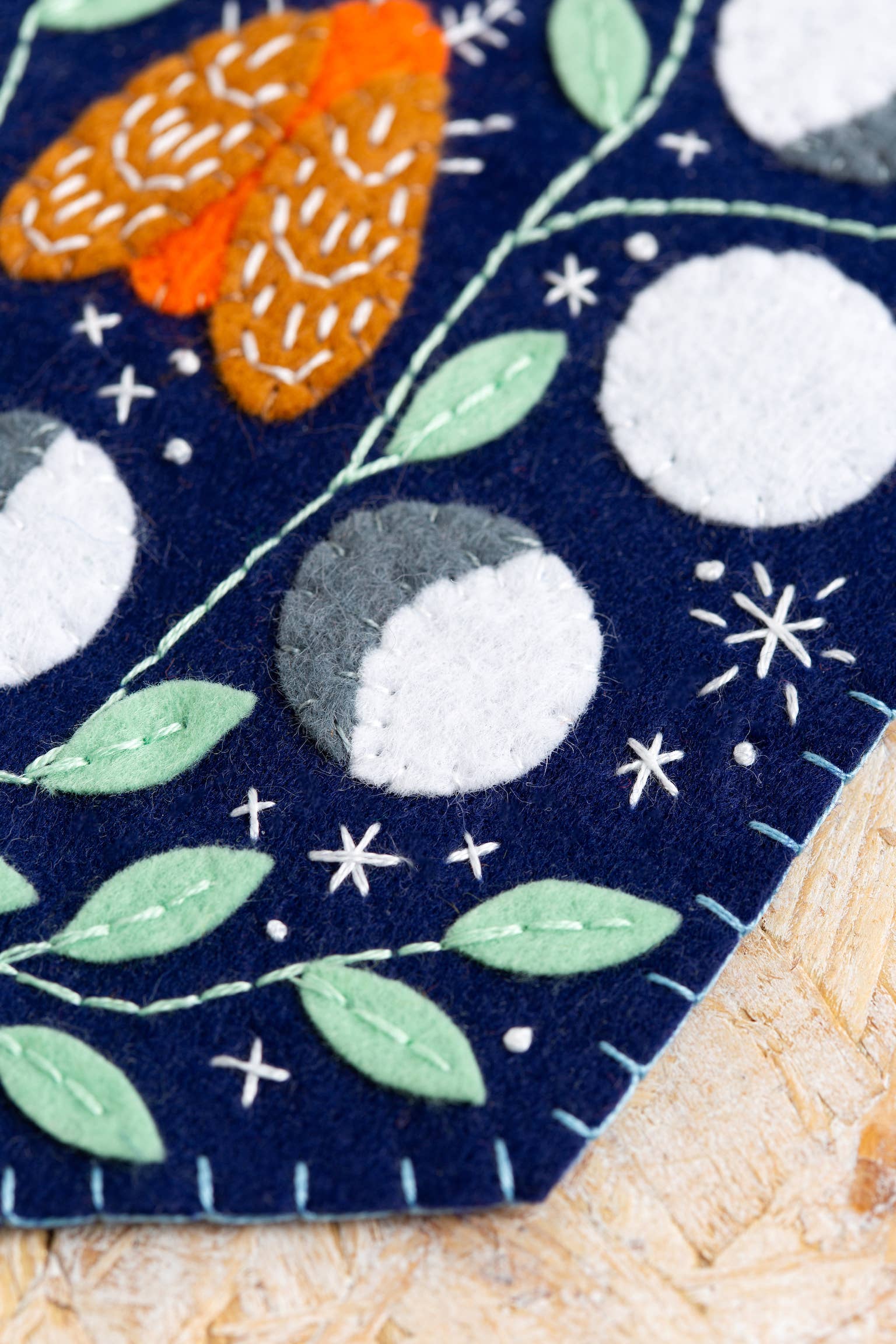 Celestial felt pennant hanging on a wall