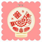 Cardinal embroidery design in three tonal colours on unbleached cotton