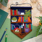 Finished Book Lover felt pennant on its wooden dowel