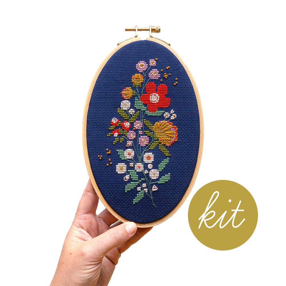 Forget-Me-Knots cross stitch kit by Junebug and Darlin, a floral bouquet in bright thread on navy cloth