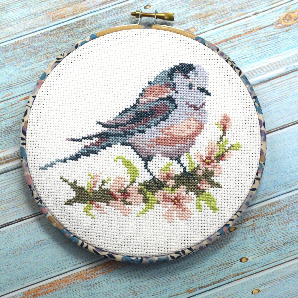 The Long-tailed Tit design worked on 14 count cotton aida, a long-tailed tit on pink blossom