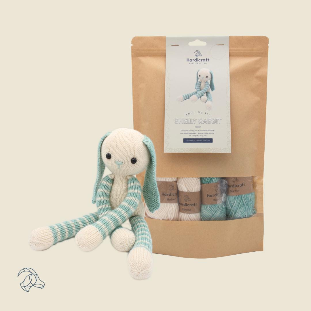 Knitted Shelly Rabbit amigurumi in white and blue marbled yarn