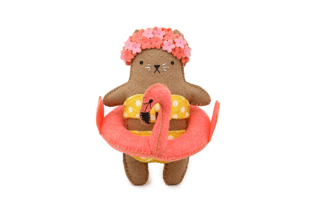 Flamingo Cat felt doll kit by Kiriki Press, a brown cat in a floral swim cap and flamingo pool float