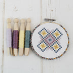 The geometric cross stitch design worked on white aida in a 4 inch hoop