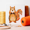 Mandala Squirrel counted cross stitch kit by Meloca Designs in shades of orange and brown
