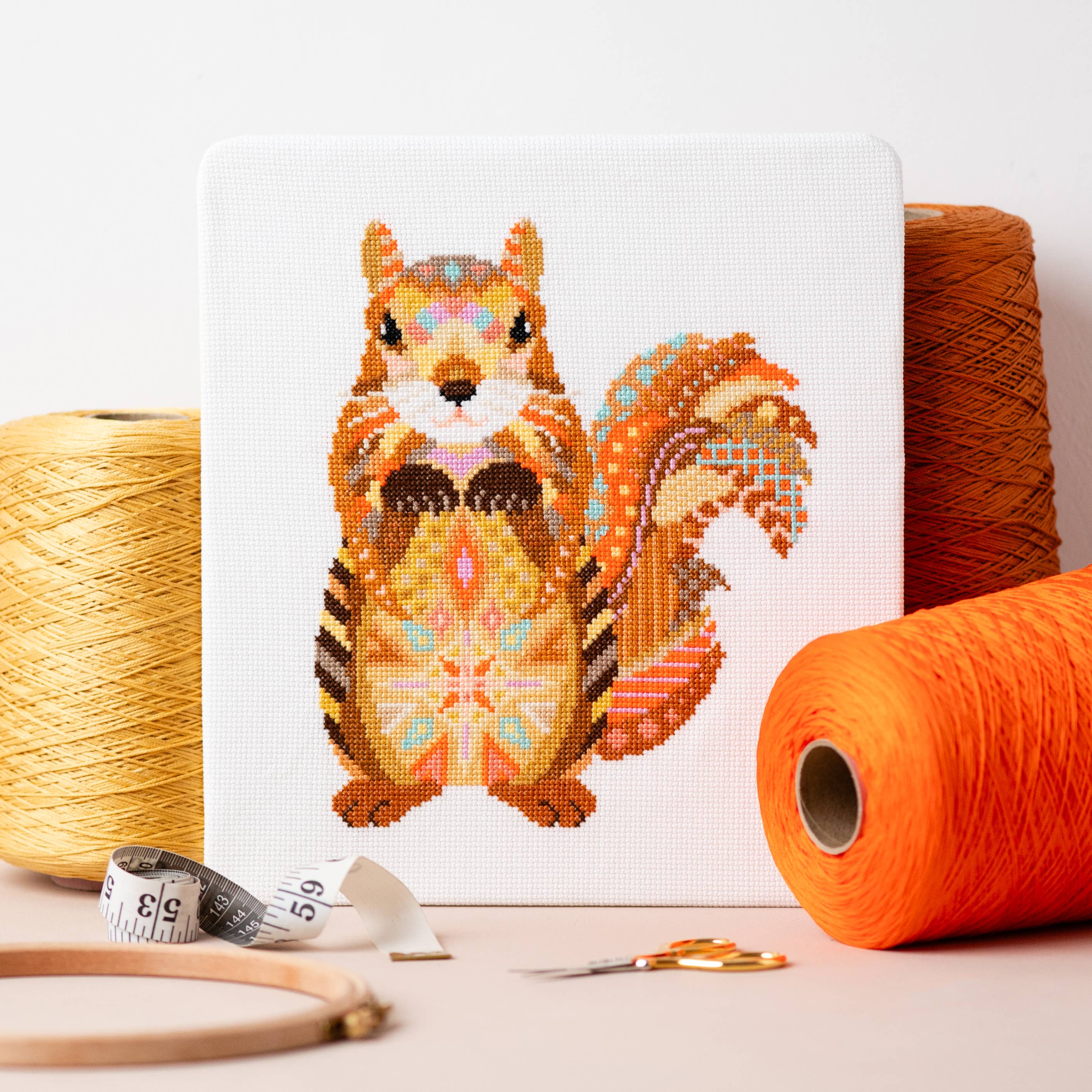 Mandala Squirrel counted cross stitch kit by Meloca Designs in shades of orange and brown