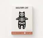 Skeleton Cat felt doll kit in its screen printed Kiriki Press packaging
