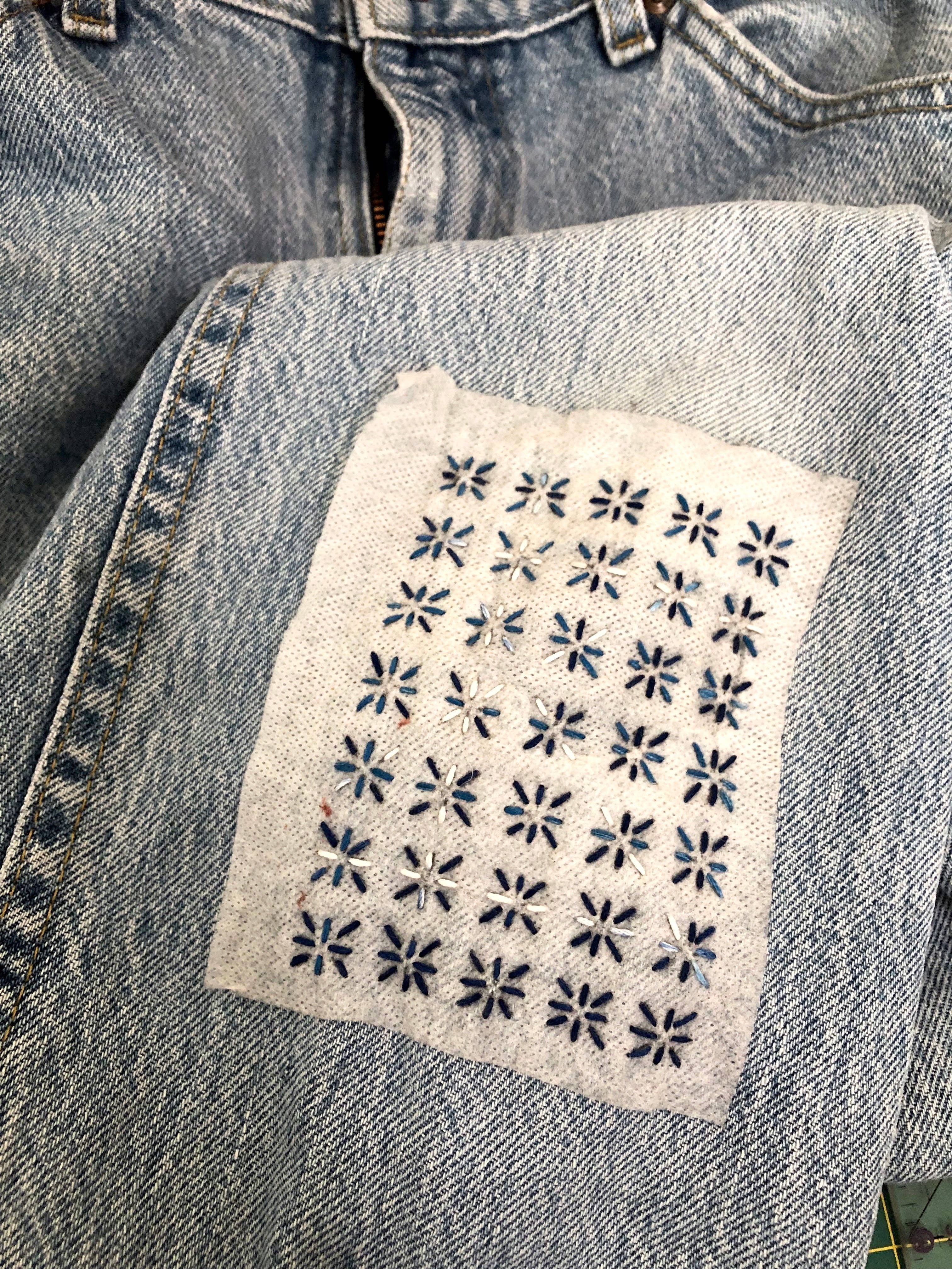 Stick the transfer over the hole, stitch the pattern, rinse the paper away