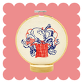 Knitting octopus embroidery design on unbleached cotton in a hoop