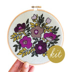 Violet Vibes cross stitch kit by Junebug and Darlin, purple floral design on sage green cloth