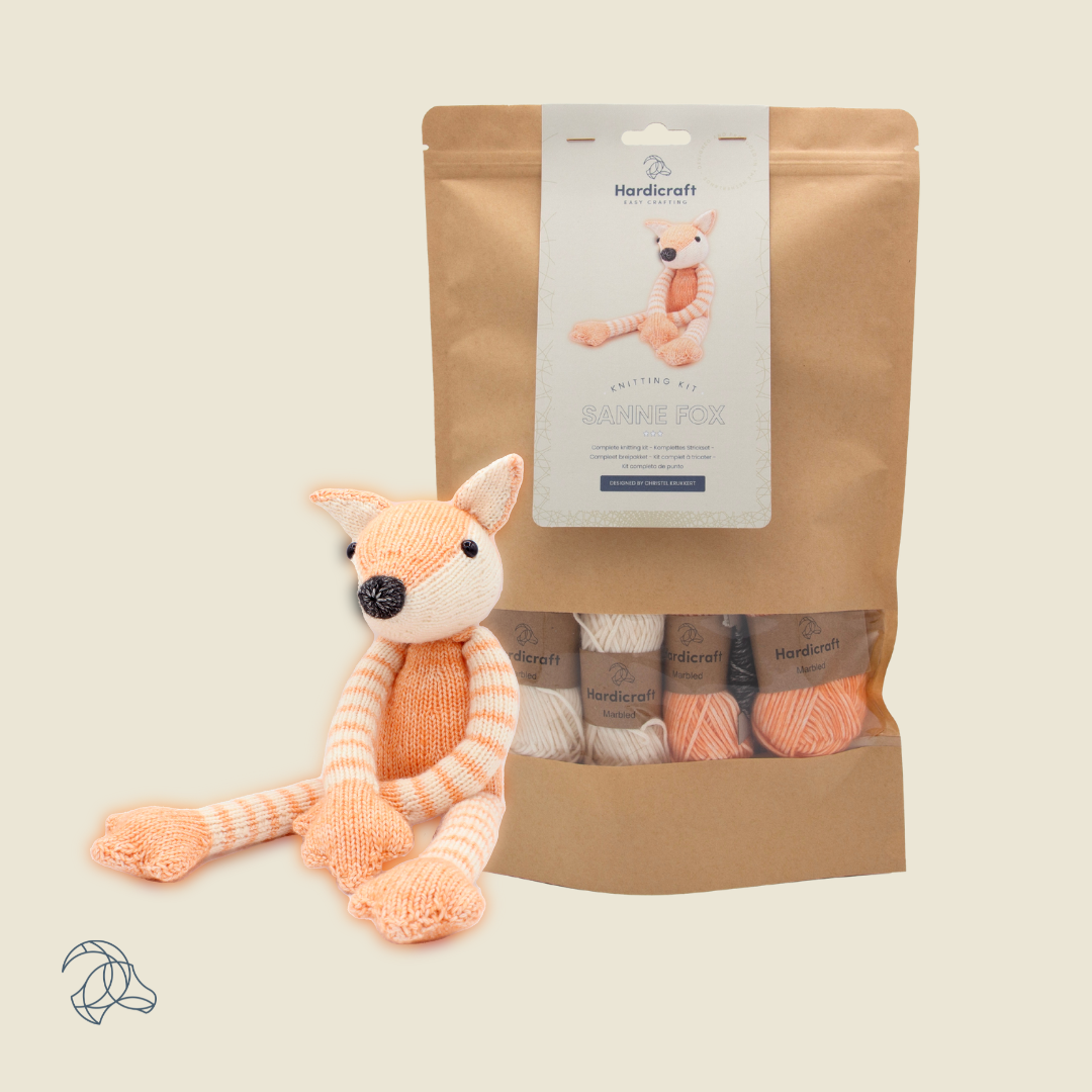 Knitted Sanne Fox amigurumi in white and orange marbled yarn