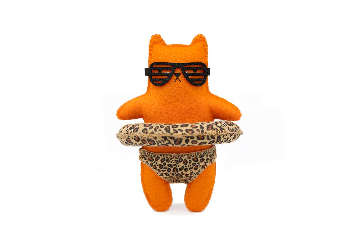 Leopard Cat felt doll kit by Kiriki Press, an orange cat in shutter shades and a leopard print pool float